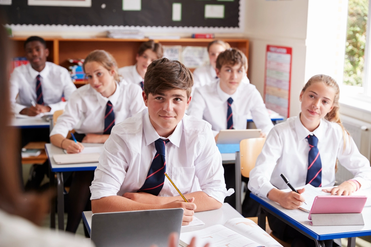 Secondary school pupils working at their desks in a classroom